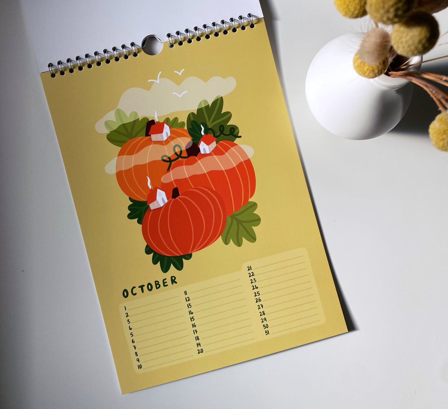 Calendar page for October with pumpkins and candles on a yellow background