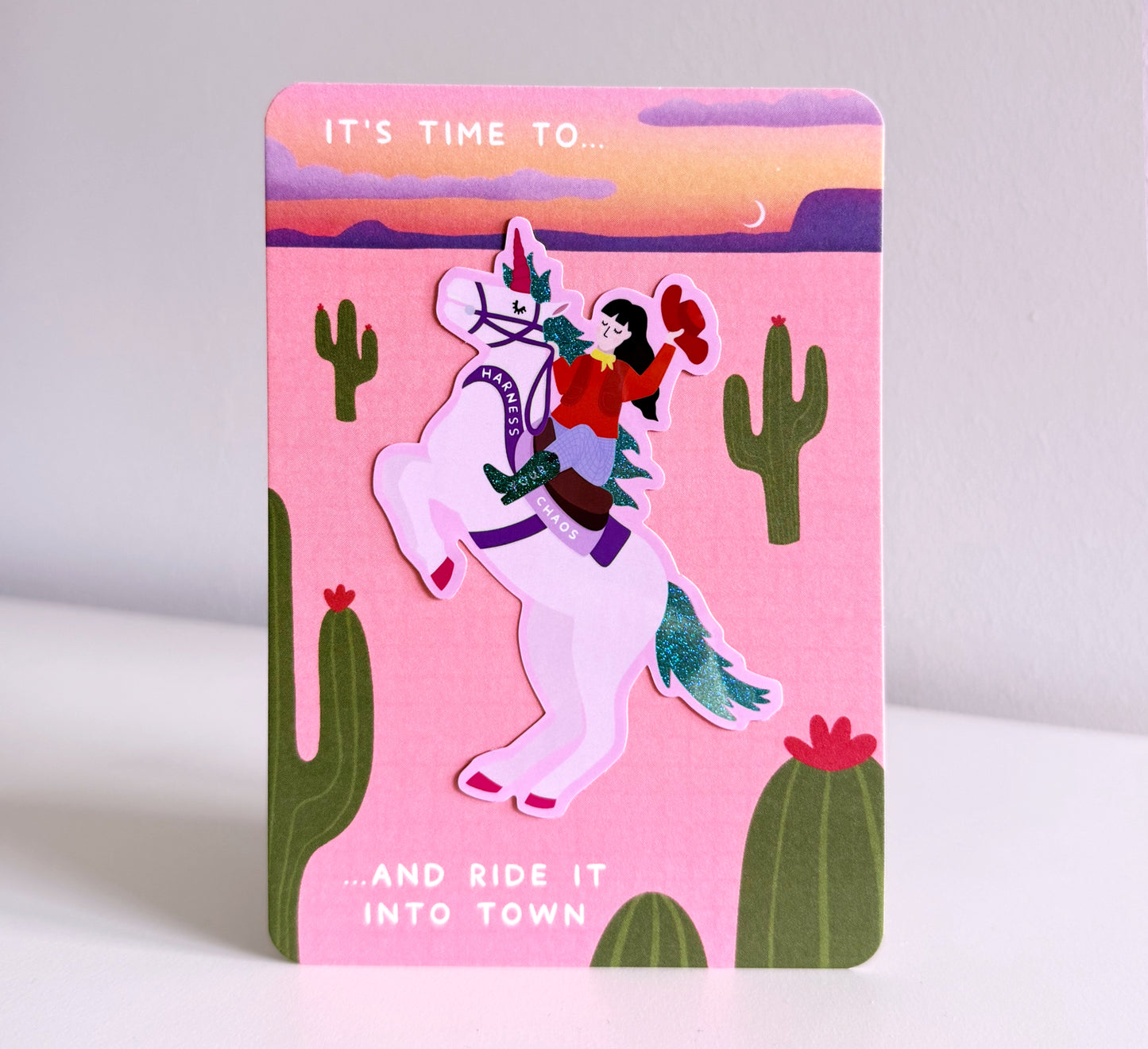 Sparkly sticker of a cowgirl riding a unicorn that says 'Harness Your Chaos' - and ride it into town. Self-love, ADHD. Neurodivergent, Neurosparkly, self-acceptance, healing, power, strong woman, gift for strong women, empowering, gift for friends.