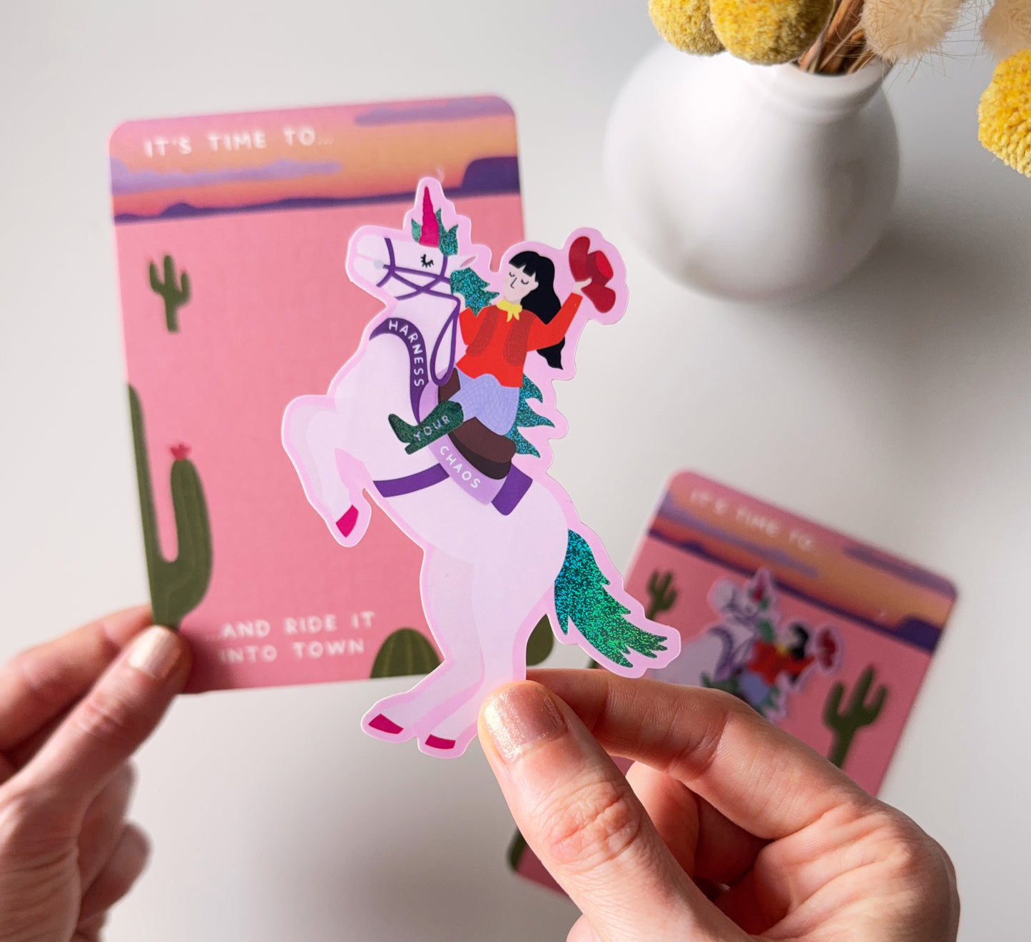 Sparkly sticker of a cowgirl riding a unicorn that says 'Harness Your Chaos' - and ride it into town. Self-love, ADHD. Neurodivergent, Neurosparkly, self-acceptance, healing, power, strong woman, gift for strong women, empowering, gift for friends.