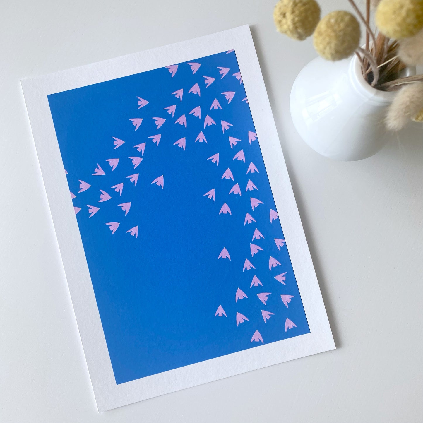 Slightly imperfect print of pink birds against a blue sky! High-quality, independently designed wall-art and prints for your home, perfect for bringing a little nature into any living space! Low-waste, sustainable, imperfect prints sale!